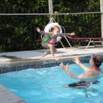 child jumping into pool